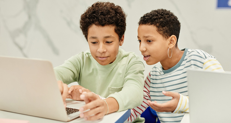Two AA kids using Computer in Class