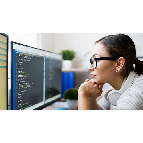 Close up of a smart young woman coding at computer.